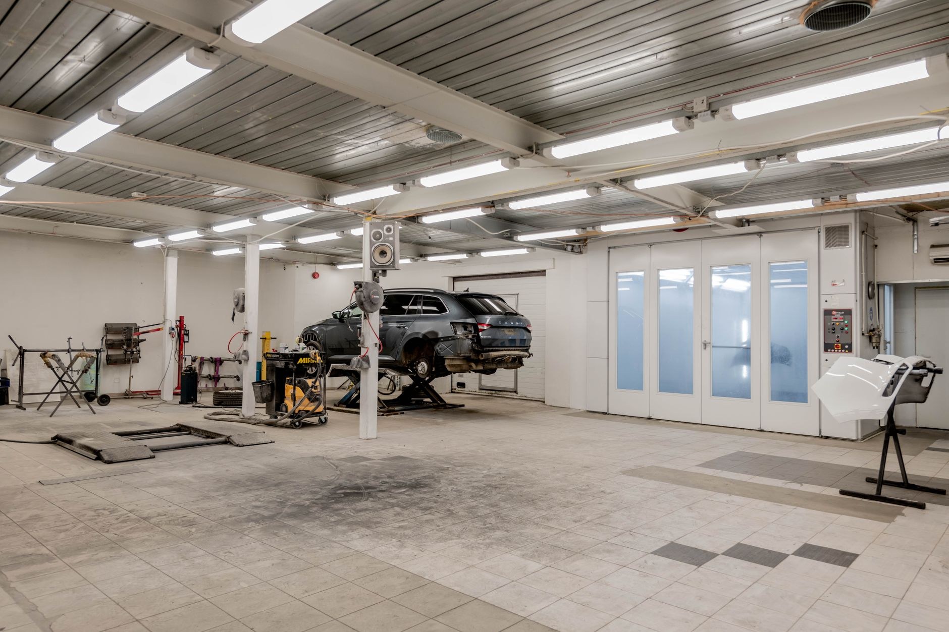 Inside the Car Care Services workshop with vehicles in the service bays